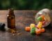 CBD gummies vs CBD oil side by side on a wooden table